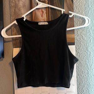 Super cute black tank worn a few times It fits like an extra small and cropped
